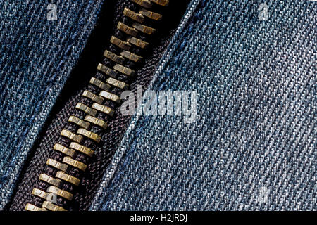 Close up and detailed shot of a metallic zip on denim Stock Photo