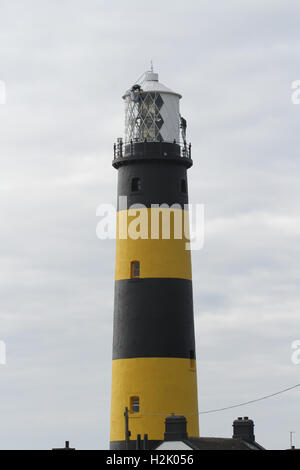 Lighthouse being painted, two men painting the outside exterior of a UK lighthouse at St John's Point County Down Northern Ireland Stock Photo