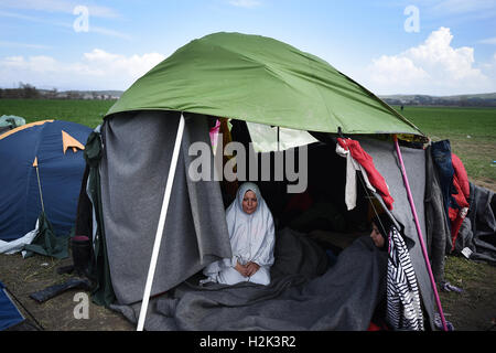 A refugee woman is seen inside a tent, at the refugee camp in the northern Greek village of Idomeni, at the Greek Macedonian border. Thousands of refugees and migrants were stranded for months at the Greek Macedonian border, at the refugee camp near the village of Idomeni, until the Greek government decided to evacuate the area. Stock Photo
