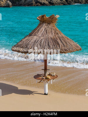 Umbrella on the beach of Paeokastritsa in Corfu Greece Stock Photo