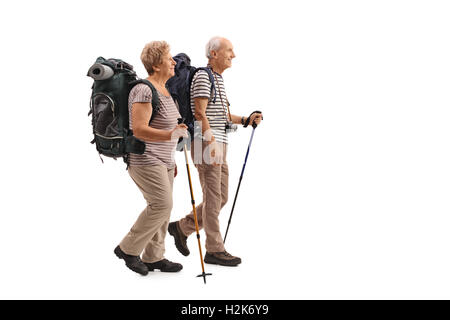 Full length profile shot of elderly hikers walking isolated on white background Stock Photo