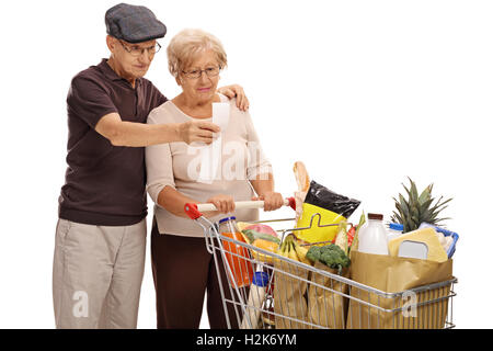 Shocked elderly couple looking at a store receipt isolated on white background Stock Photo
