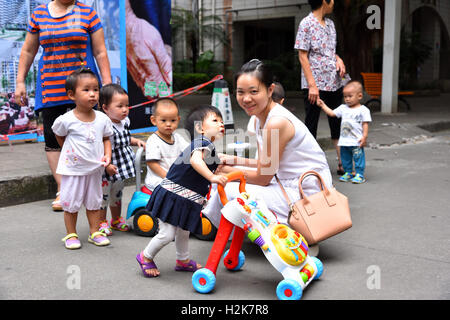 Group of Chinese children and their mums with kids having fun. Stock Photo