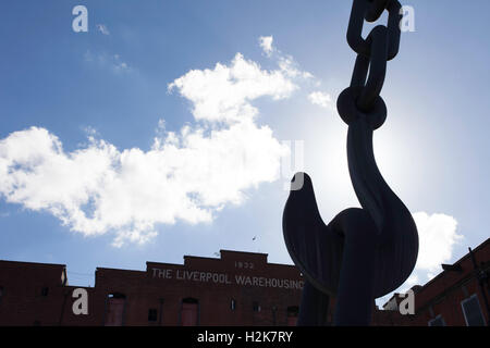 An iconic old crane in silhouette in front of The Liverpool Warehousing Company building in Salford Quays, Manchester. Stock Photo