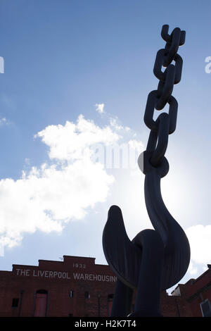 An iconic old crane in silhouette in front of The Liverpool Warehousing Company building in Salford Quays, Manchester. Stock Photo