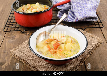 cullen skink, typical scottish food with smoked haddock in a pot and bowl on jute Stock Photo