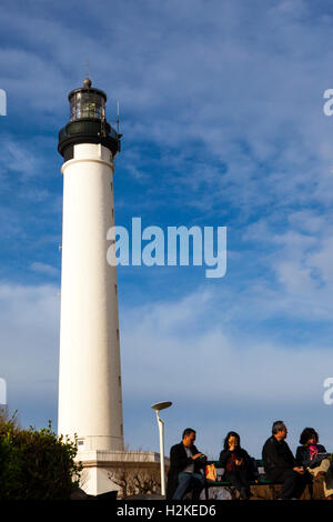 Tourists picnic beside the Phare de Biarritz Biarritz lighthouse, Basque Country, France Stock Photo