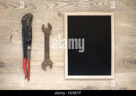 Rusty old hand tools with empty blackboard Stock Photo