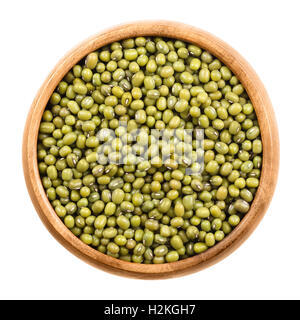 Mung beans in a wooden bowl on white background. Dried beans of Vigna radiata, also moong bean, green gram or mung, a legume. Stock Photo