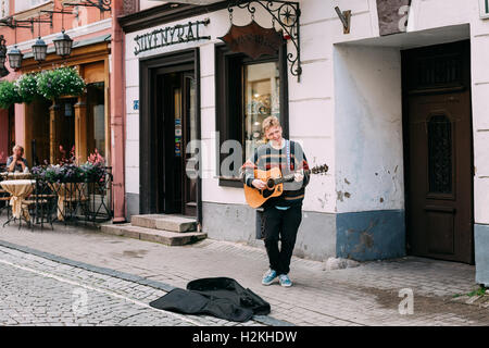 Vilnius, Lithuania - July 09, 2016: The Young Guy, The Street Musician Playing Guitar And Singing Song For Donation In Tourist P Stock Photo