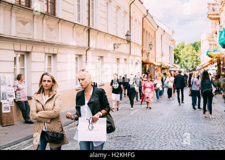 Vilnius, Lithuania - July 09, 2016: Two Women Walking On The Crowded Pedestrian Paved Street And Talking To Each Other In Summer Stock Photo