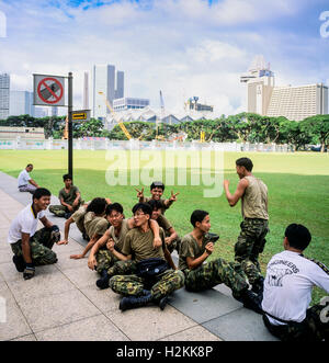 Army servicemen having a break, Padang ground, Singapore Stock Photo