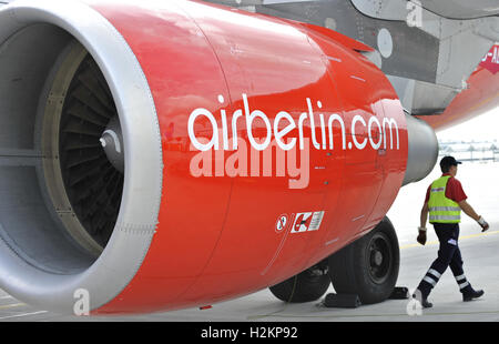 (FILE) - A file picture dated 14 August 2010 shows an employee of the airport walking past an engine of a plane of Air Berlin in Munich, Germany. On 18 November 2010, Air Berlin presents its figures for the third quarter of the year. Photo: Andreas Gebert | usage worldwide Stock Photo