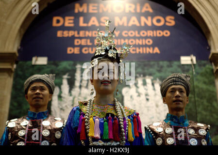 Mexico City, Mexico. 28th Sep, 2016. A woman and two men in traditional costumes are highlighted at the opening ceremony of the exhibition 'Memory of the Hand - Splendor and Colorful Heritage of Guizhou' at the National Museum of Cultures in Mexico City, capital of Mexico, Sept. 28, 2016. Embroidered costumes, paper cutting, wooden masks and silver jewelry of the Guizhou province, part of its variety of intangible heritage of China, are displayed during the exhibition at the National Museum Cultures of Mexico. © Carlos Ramirez/Xinhua/Alamy Live News Stock Photo