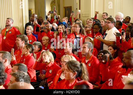 Members of the 2016 US Olympic and Paralympic teams use their cell phones to take photos as United States President Barack Obama and first lady Michelle Obama welcome them to the East Room of the White House in Washington, DC to honor their participation and success in this year’s Games in Rio de Janeiro, Brazil. Credit: Ron Sachs / Pool via CNP /MediaPunch Stock Photo