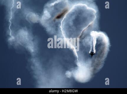 An F-16 Fighting Falcon aircraft performs during the Heritage Flight ...