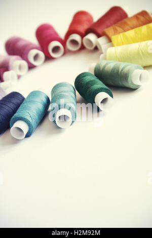 Sewing threads of different colors in beautiful pattern Stock Photo