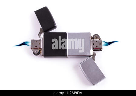 Silver metal lighters on white background with blue flame. Stock Photo