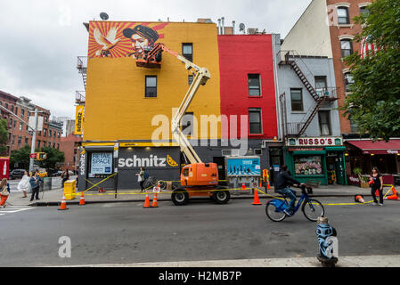 New York, USA, 28 September 2016 - Shepard Fairey mural goes up on the wall of a building in New York City's East Village.. Titled Viva La Revolucion'  the painting features Fairey's oldest daughter and was originally created in 2008. ©Stacy Walsh Rosenstock Stock Photo