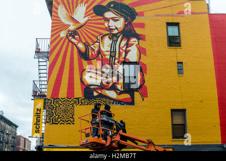New York, NY 29 September 2016 Shepard Fairey mural goes up on the wall of a building in New York City's East Village.. Titled Viva La Revolucion'  the painting features Fairey's oldest daughter and was originally created in 2008. ©Stacy Walsh Rosenstock Stock Photo