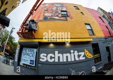 New York, NY 29 September 2016 SShepard Fairey mural goes up on the wall of a building in New York City's East Village.. Titled Viva La Revolucion'  the painting features Fairey's oldest daughter and was originally created in 2008. ©Stacy Walsh Rosenstock Stock Photo