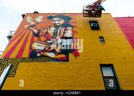 New York, NY 29 September 2016 Shepard Fairey mural goes up on the wall of a building in New York City's East Village.. Titled Viva La Revolucion'  the painting features Fairey's oldest daughter and was originally created in 2008. ©Stacy Walsh Rosenstock Stock Photo