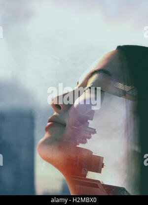 Double exposure of young woman and cityscape Stock Photo