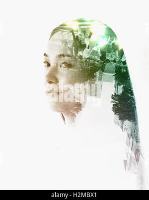 Double exposure of young woman and cityscape Stock Photo