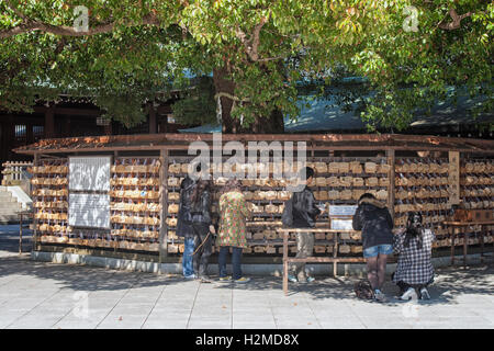 People hanging prayer tablets at the Shinto Meiji Jingu Shrine,Shibuya-Ku,Tokyo,Japan Stock Photo