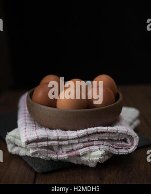 Eggs in a bowl with tea towels Stock Photo
