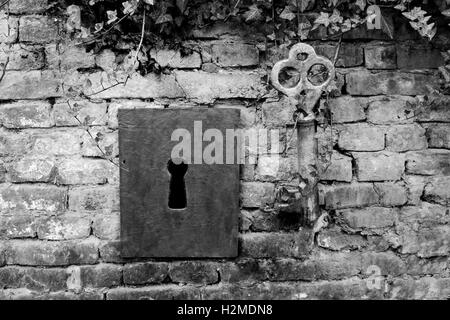 Vintage Giant Key And Keyhole On The Brick Wall Stock Photo