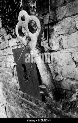 Vintage Giant Key And Keyhole On The Brick Wall Stock Photo