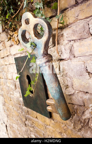 Vintage Giant Key And Keyhole On The Brick Wall Stock Photo