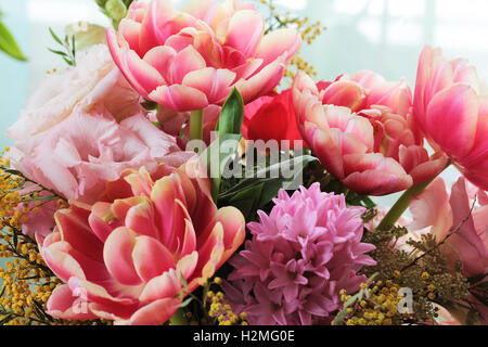 Bouquet of different flowers including tulips and mimosa Stock Photo