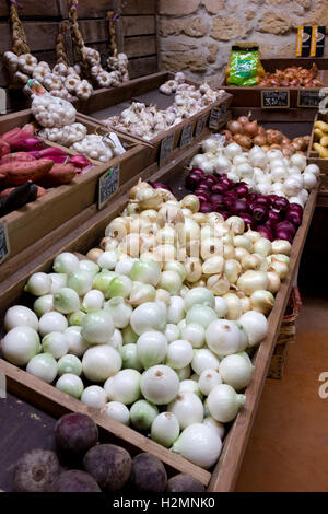 Onions and Garlic for sale in a French greengrocers Stock Photo