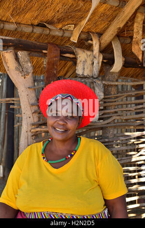 Shakaland Zulu lady troupe member poses in a traditional  Zulu hat at the  Shakaland Cultural Village Stock Photo