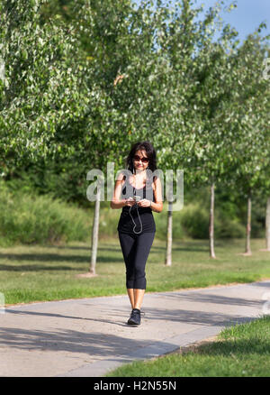 Asian American woman walking on a path Stock Photo