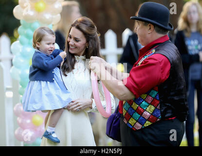 The Duchess of Cambridge holding Princess Charlotte with an entertainer at a children's party at a children's party for Military families at Government House in Victoria during the Royal Tour of Canada. Stock Photo