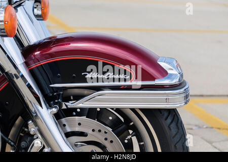 The front wheel of a deep red Harley Davidson Ultra Classic motorcycle, closeup. Oklahoma City, Oklahoma, USA. Stock Photo