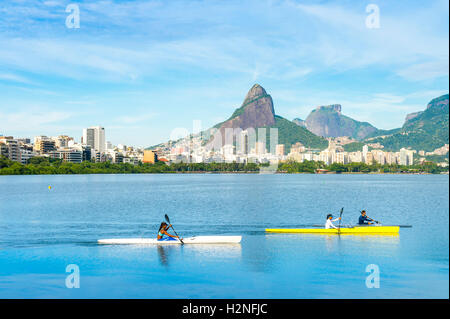 RIO DE JANEIRO - MARCH 12, 2016: Rowers on morning practice make their way across Lagoa Rodrigo de Freitas lagoon. Stock Photo
