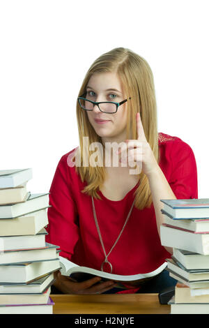 Young blond woman studying with stacks of books Stock Photo