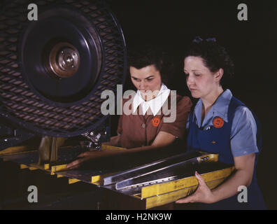 Two Female Workers Punching Holes in Frame Member for B-25 Bomber, North American Aviation, Inc, Inglewood, California, USA, Alfred T. Palmer, U.S. Office of War Information, June 1942 Stock Photo