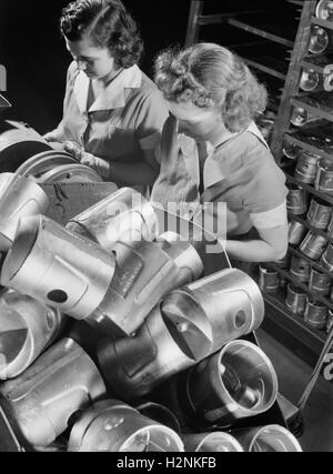 Two Female Workers Inspecting Heat-Treated Pistons prior to Brinnell hardness Testing at Aluminum Factory Converted to War Production, Aluminum Industries, Inc., Cincinnati, Ohio, USA, Alfred T. Palmer for Office of War Information, February 1942 Stock Photo