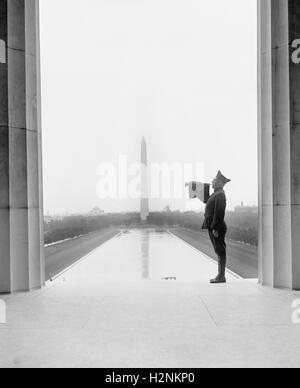 Soldier Playing Taps after Funeral of U.S. President Warren G. Harding, Washington Monument in Background, Washington DC, USA, National Photo Company, August 10, 1923 Stock Photo