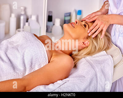 Woman middle-aged take face cleaning in spa salon. Stock Photo