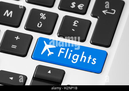 Close-up of blue flights button on keyboard for online check-in Stock Photo