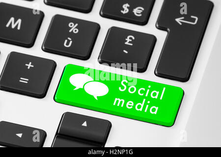Close up of green social media button on keyboard with speech bubbles Stock Photo