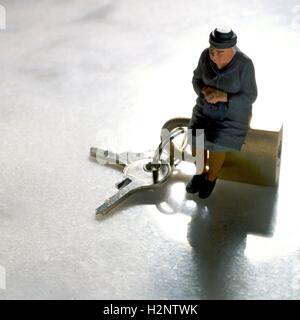 Grandmother, figurine, and keys, symbolic image for departure to old people's home Stock Photo