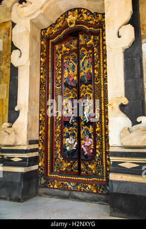 Indonesia, Bali, Tengannan, Bali Aga village, decoratively carved painted doorway in wealthy house compaund Stock Photo