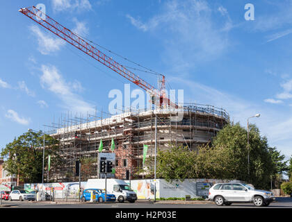 Tower crane on a construction site for the building of new retirement apartments by McCarthy and Stone, West Bridgford, Nottinghamshire, England, UK Stock Photo